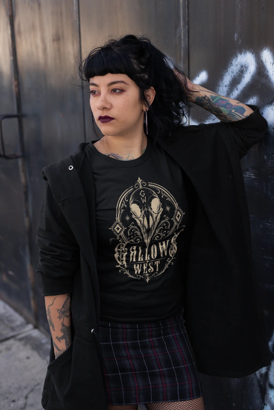 Model wearing a black Gallows West skull-sigil T-shirt